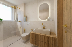 Světlá koupelna s béžovým obkladem, zlatými bateriemi, dřevěnou skříňkou s deskovým umyvadlem a sprchou u okna