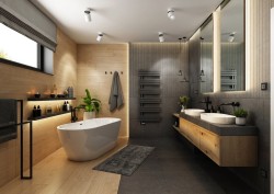 Luxusní velká koupelna s volně stojící vanou, dvojicí miskových umyvadel na dlouhé desce, obklady v dřevodekoru a tmavou stěnou s designovým radiátorem